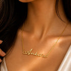 Gold necklace with 'Ankita' on a person's neck